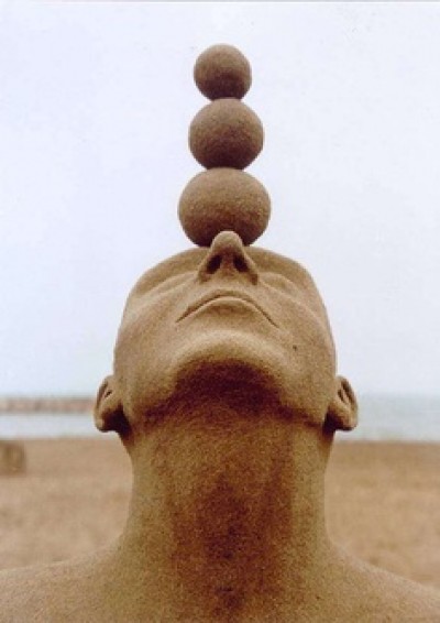 The balancing act sand sculpture